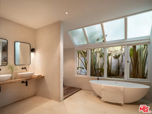 a bathroom with a sink mirror and toilet