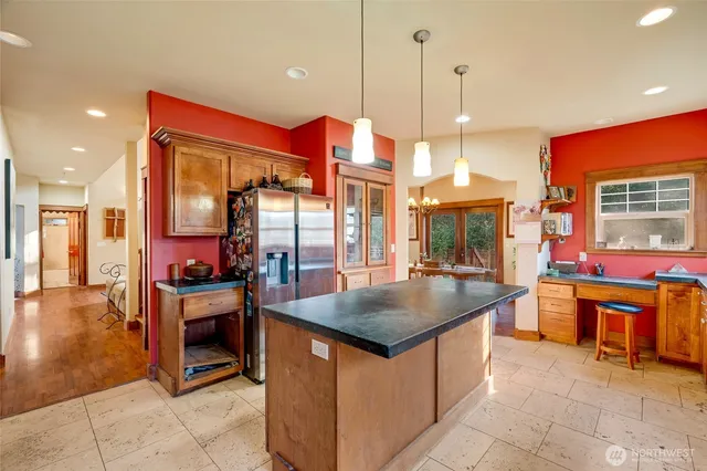 a kitchen with stainless steel appliances granite countertop a stove and a kitchen island