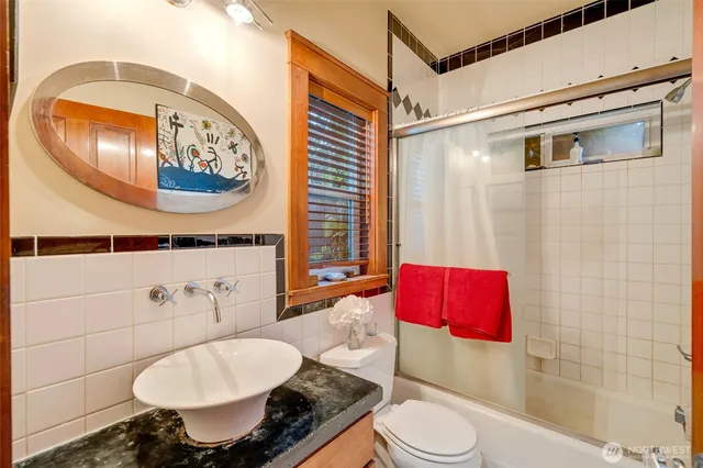a bathroom with a toilet sink and mirror