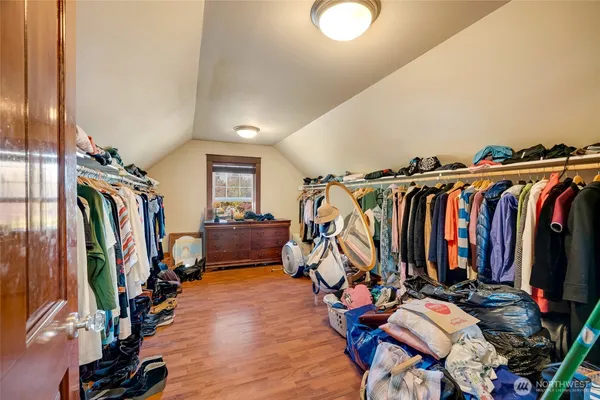 a view of walk in closet with clothes