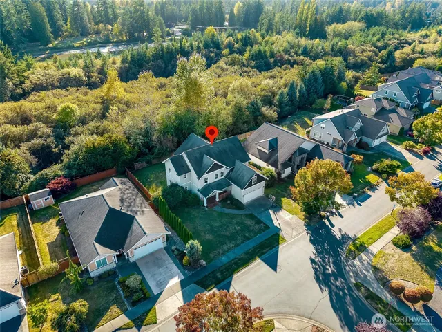 an aerial view of multiple houses with yard