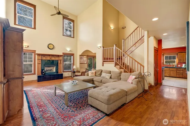 a living room with fireplace furniture and a wooden floor
