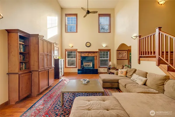 a living room with furniture fireplace and wood floor