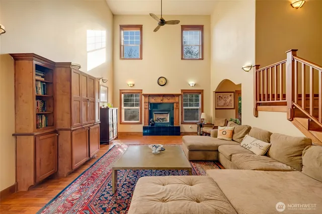 a living room with furniture fireplace and wood floor
