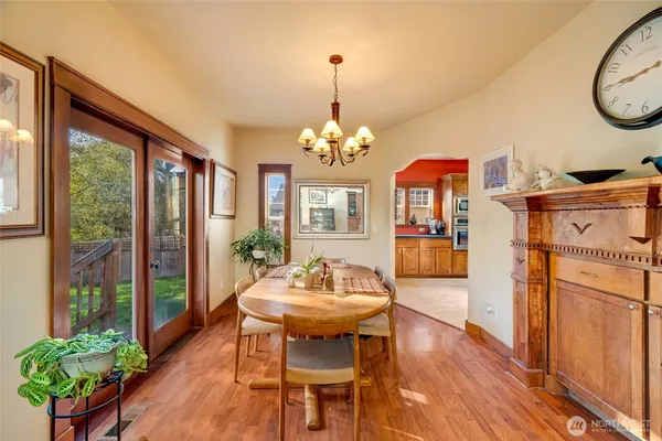 a dining room with furniture a chandelier and wooden floor