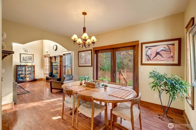 a view of a dining room with furniture wooden floor and chandelier