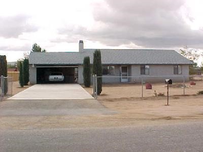22331 Kayenta Road Apple Valley, CA 92308 - Photo 1 of 1 a front view of a house with a garage