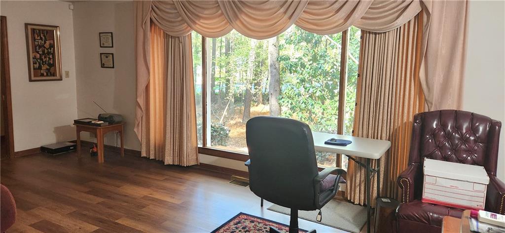 3140 Flat Shoals Road Atlanta, GA 30349 - Photo 4 of 16 a view of a workspace with furniture and a window