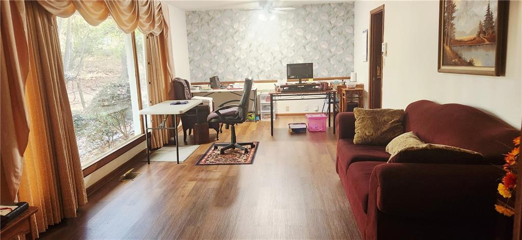 3140 Flat Shoals Road Atlanta, GA 30349 - Photo 5 of 16 a living room with furniture and a floor to ceiling window