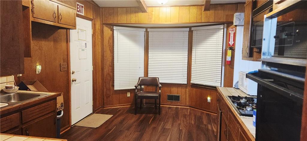 3140 Flat Shoals Road Atlanta, GA 30349 - Photo 6 of 16 a view of a kitchen with wooden floor and furniture