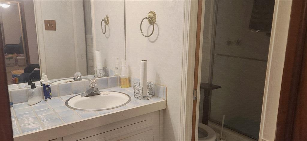 3140 Flat Shoals Road Atlanta, GA 30349 - Photo 10 of 16 a bathroom with a sink and a mirror