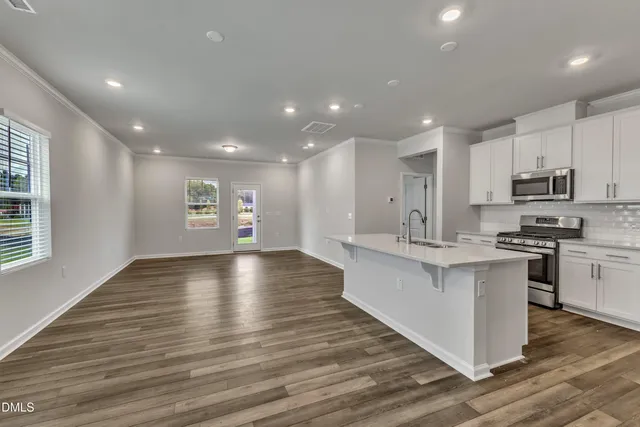 a view of kitchen with sink stainless steel appliances and window