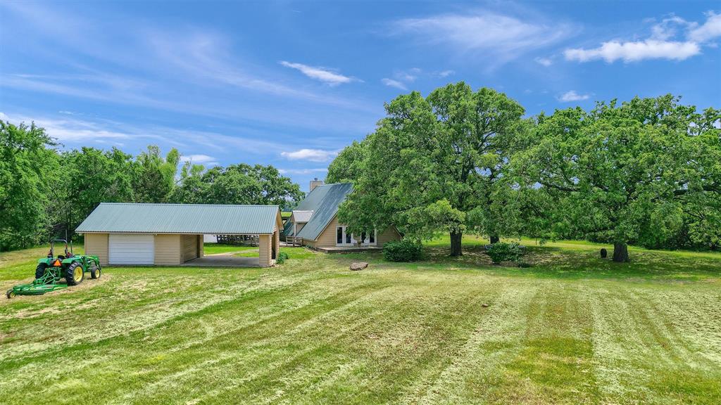 263 Rio Roxo Road Gordonville, TX 76245 - Photo 11 of 33 View of yard featuring a garage and an outdoor structure