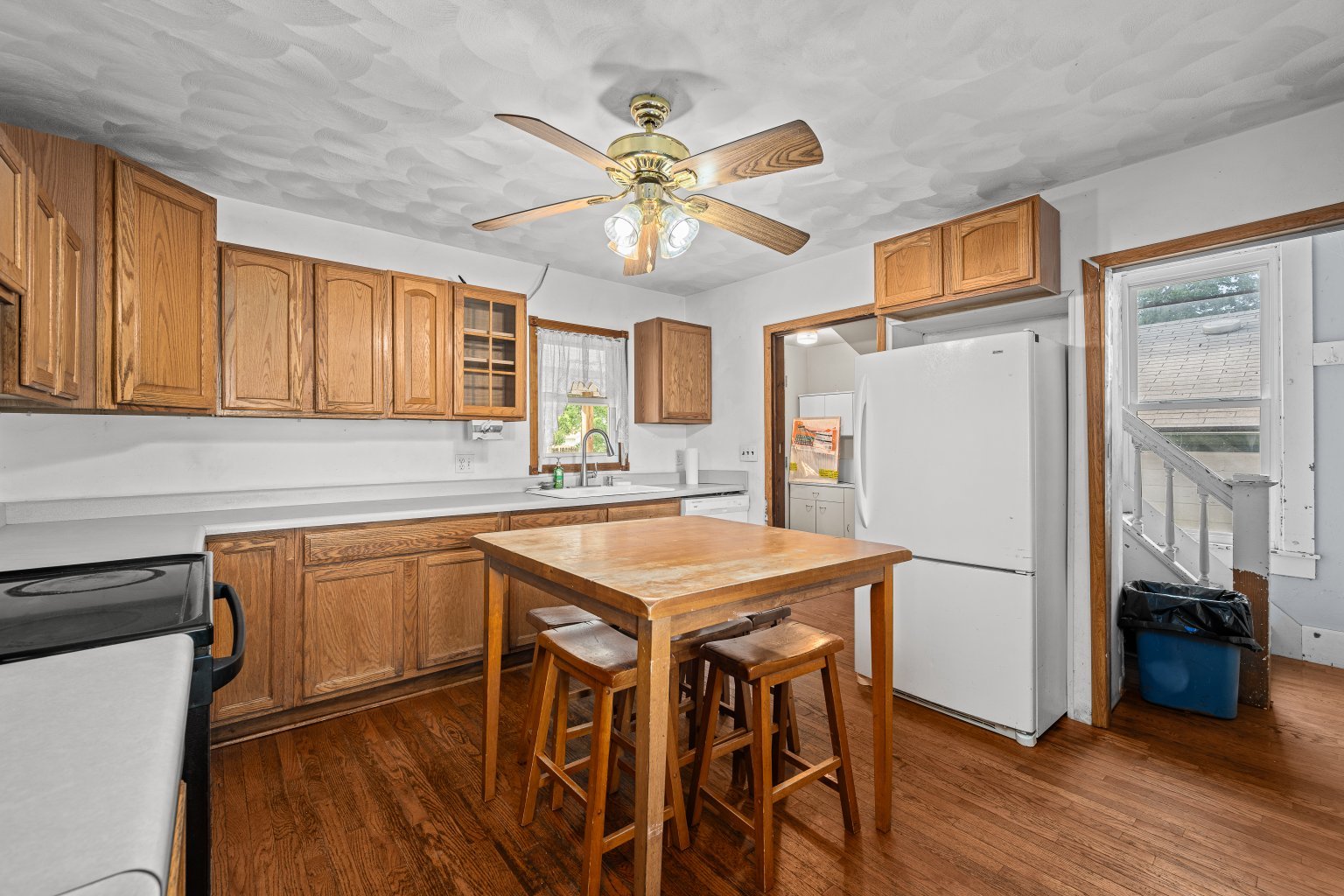 200 West Locust Street Cambridge, IL 61238 - Photo 12 of 32 a kitchen with stainless steel appliances granite countertop a refrigerator a sink dishwasher a stove and white countertops with wooden floor
