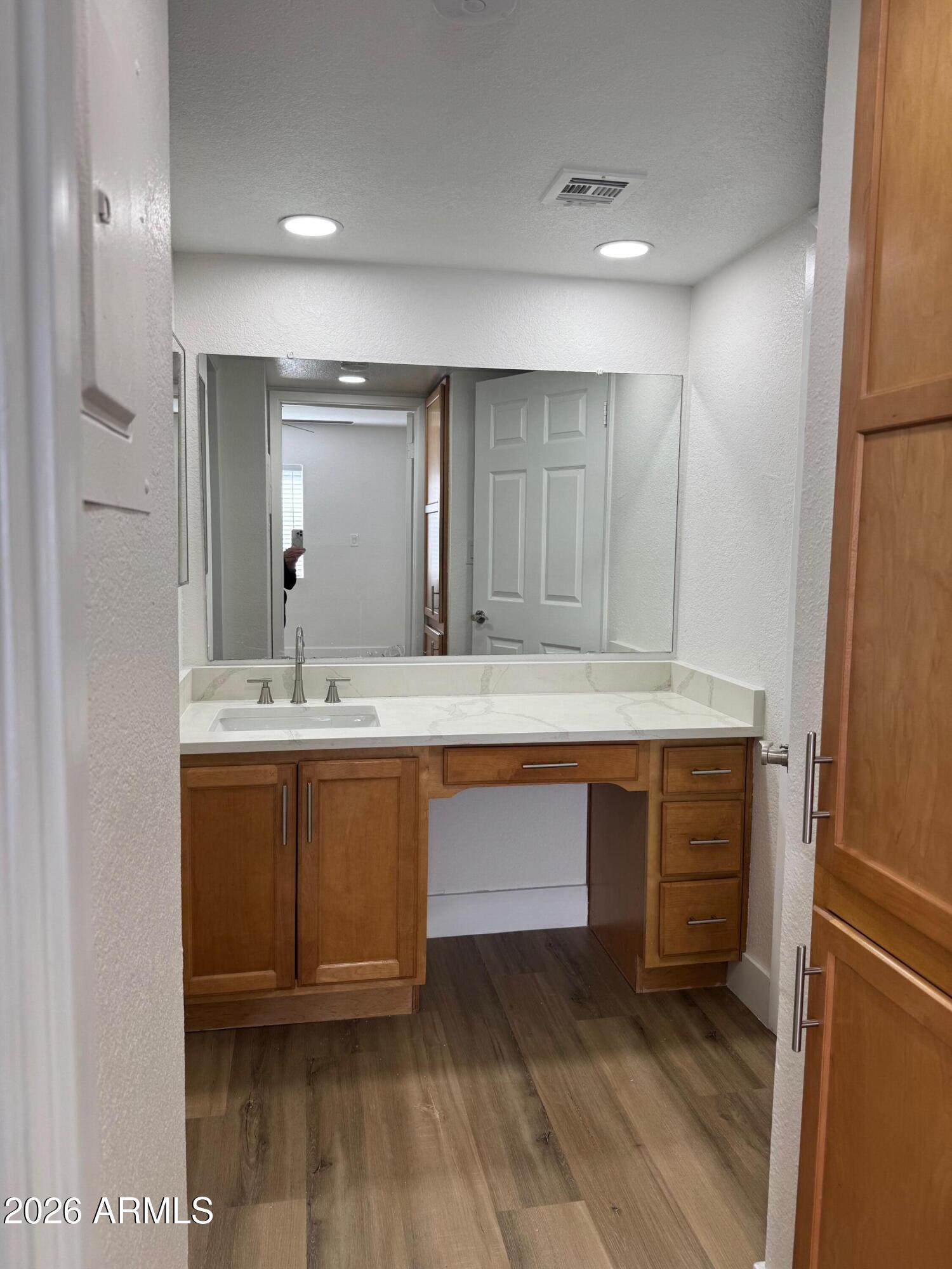 3825 East Camelback Road, Unit 226 Phoenix, AZ 85018 - Photo 15 of 20 a bathroom with a sink and a mirror
