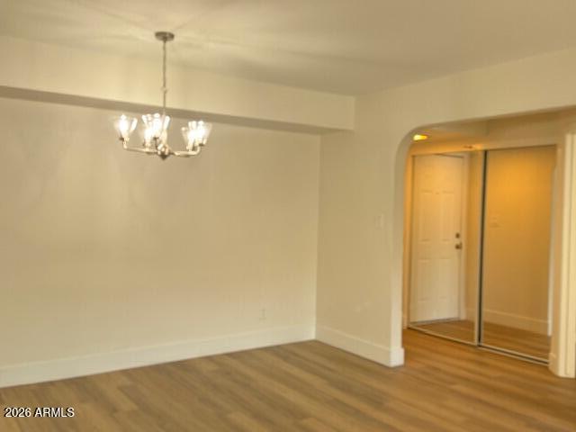 3825 East Camelback Road, Unit 226 Phoenix, AZ 85018 - Photo 18 of 20 a view of a room with wooden floor and chandelier