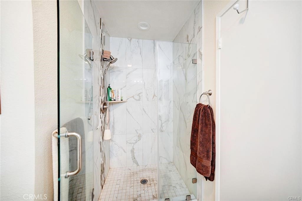13556 La Jolla Circle, Unit 208H La Mirada, CA 90638 - Photo 16 of 39 a bathroom with a shower and a mirror