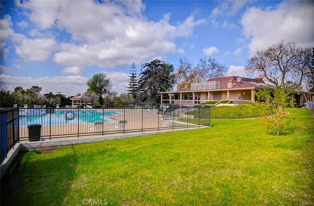 a view of a swimming pool and lounge chairs