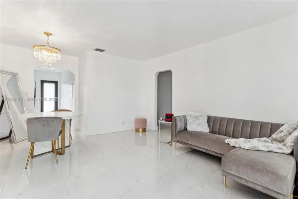 a living room with furniture and a dining room