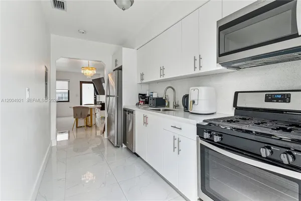 a kitchen with stainless steel appliances a stove a microwave and cabinets