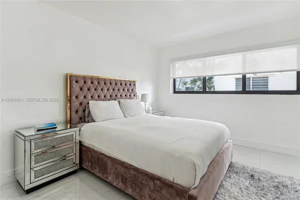 a bedroom with a bed and cabinet