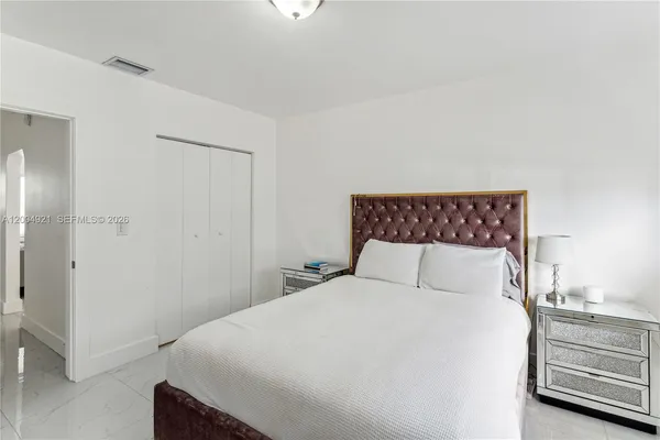 a bedroom with a bed and a night stand