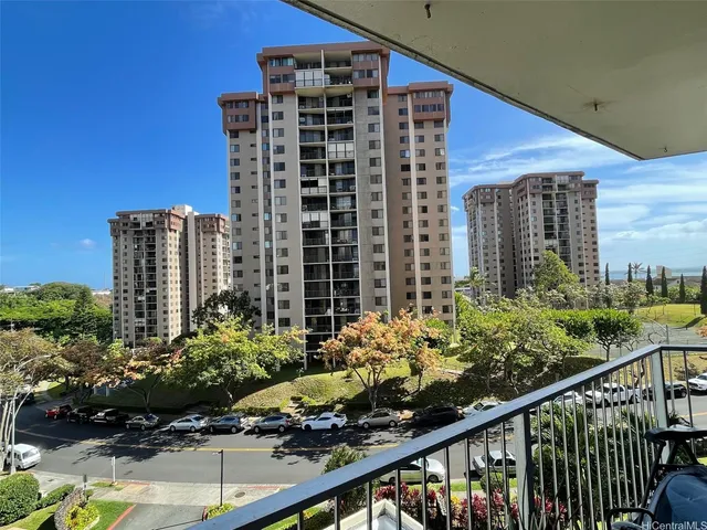 a view of a balcony with chairs and potted plants