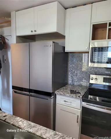 a kitchen with a refrigerator and a sink