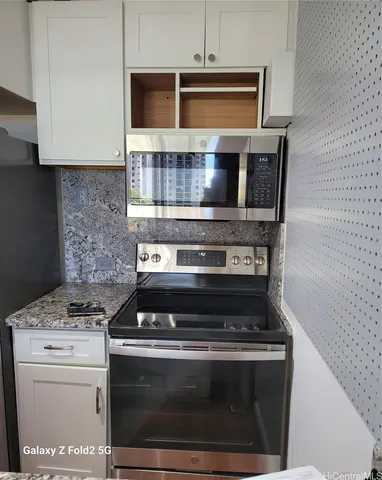 a stove top oven sitting inside of a kitchen
