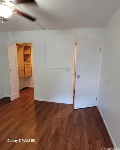 an empty room with wooden floor and closet