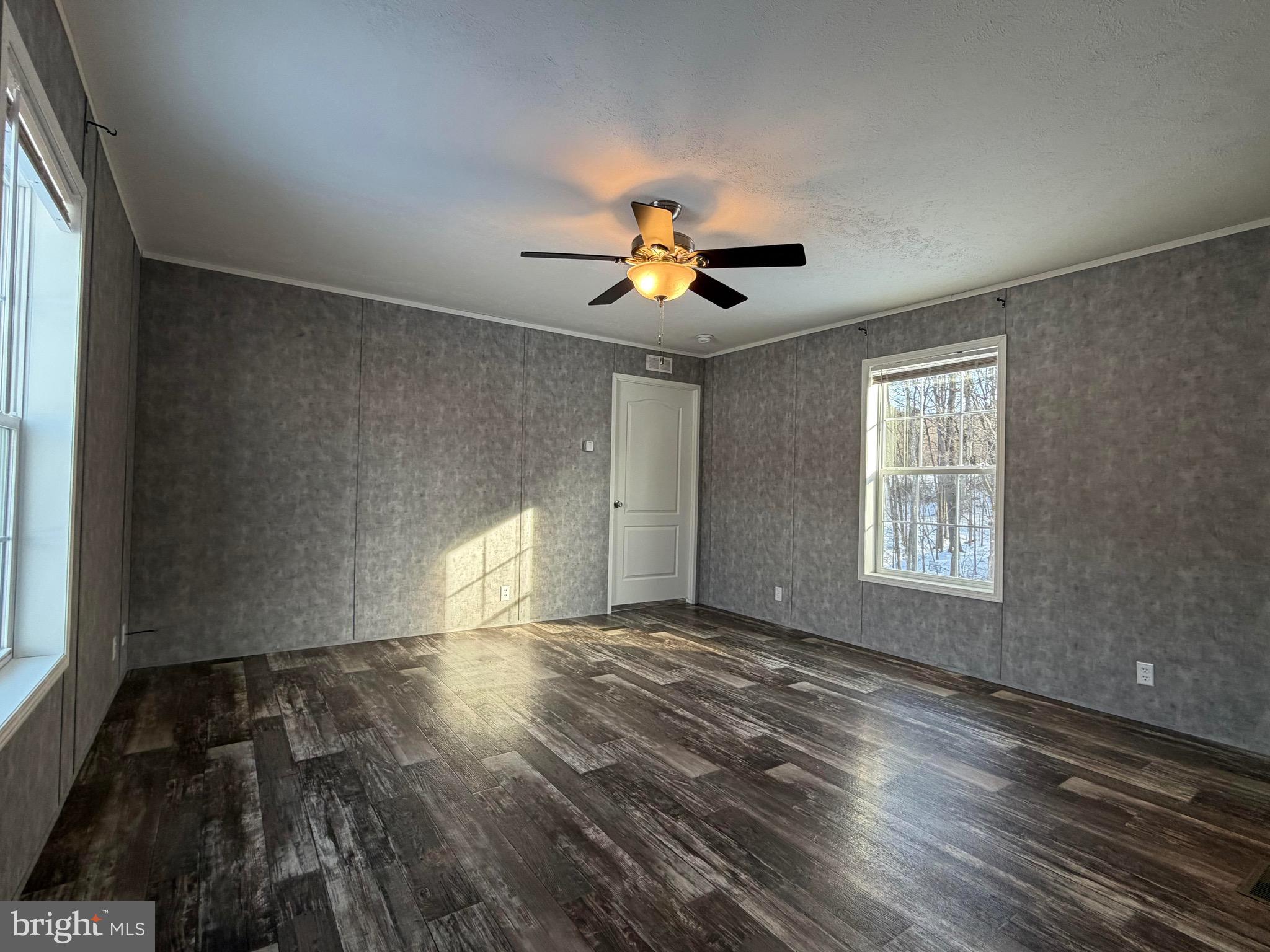 425 Cider Press Road Lock Haven, PA 17745 - Photo 11 of 38 a view of empty room with wooden floor and fan