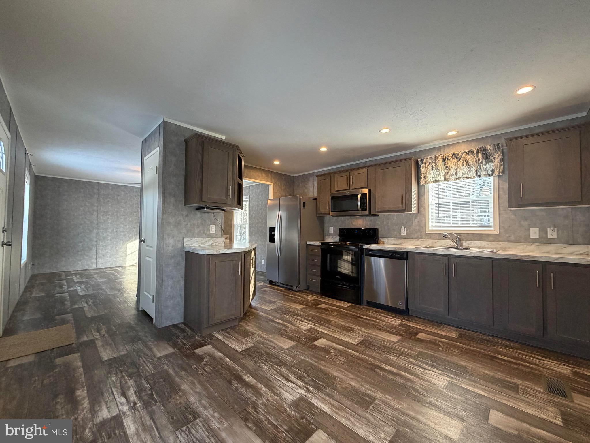 425 Cider Press Road Lock Haven, PA 17745 - Photo 20 of 38 a kitchen with stainless steel appliances kitchen island granite countertop a refrigerator and a stove top oven