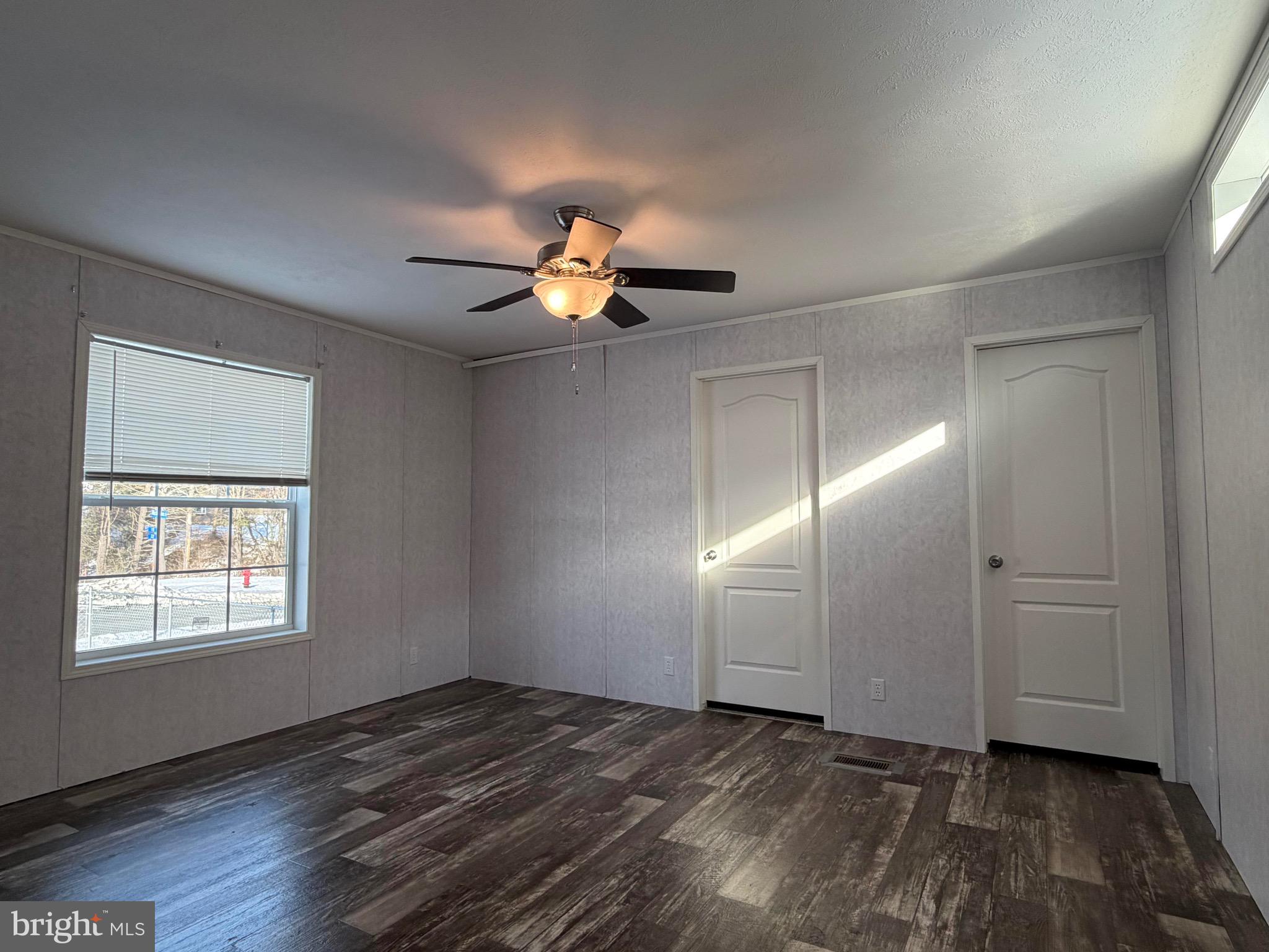 425 Cider Press Road Lock Haven, PA 17745 - Photo 36 of 38 an empty room with wooden floor chandelier fan and windows