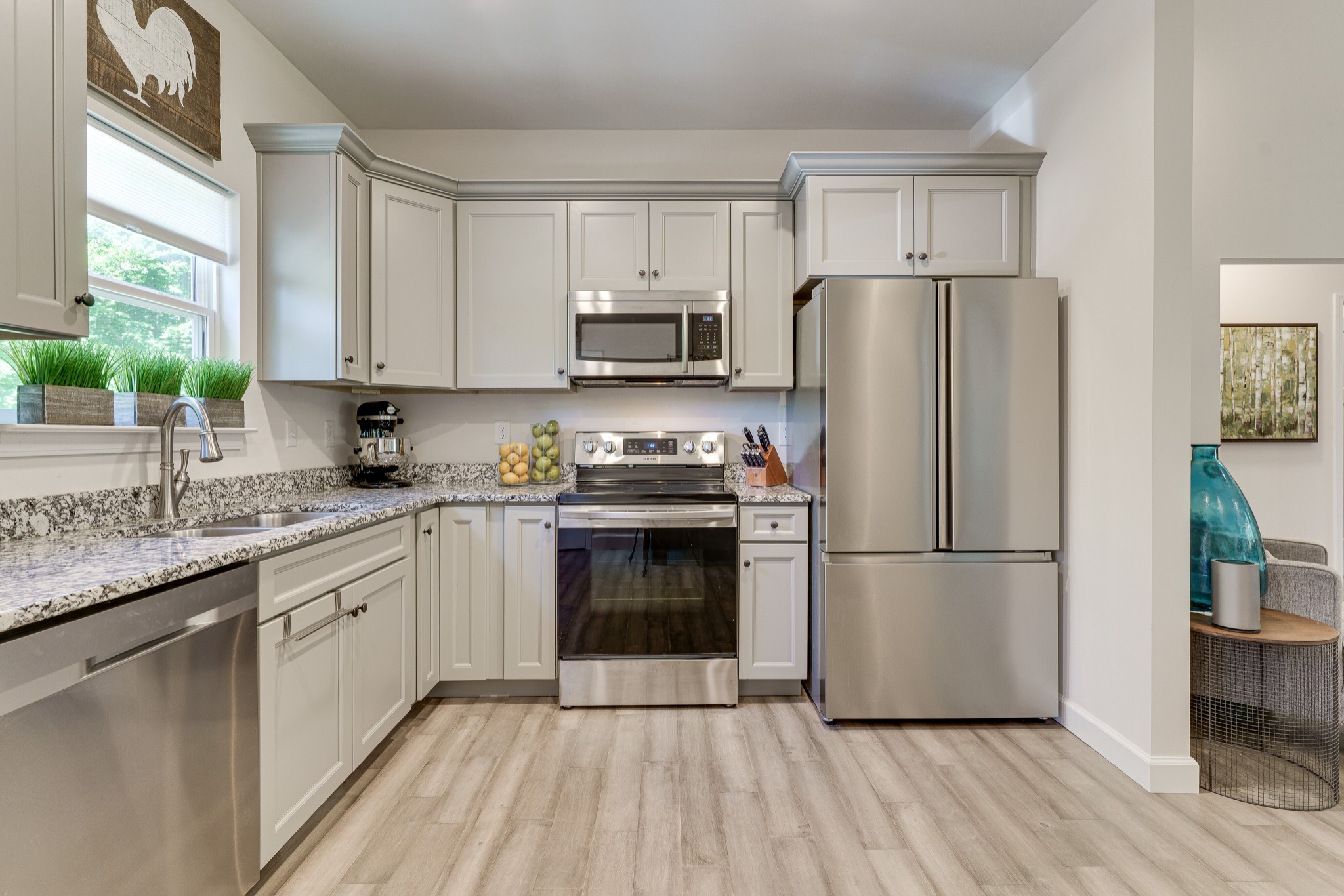 1170 Cowan Road Dickson, TN 37055 - Photo 12 of 30 a kitchen with a refrigerator stove and sink with wooden floor