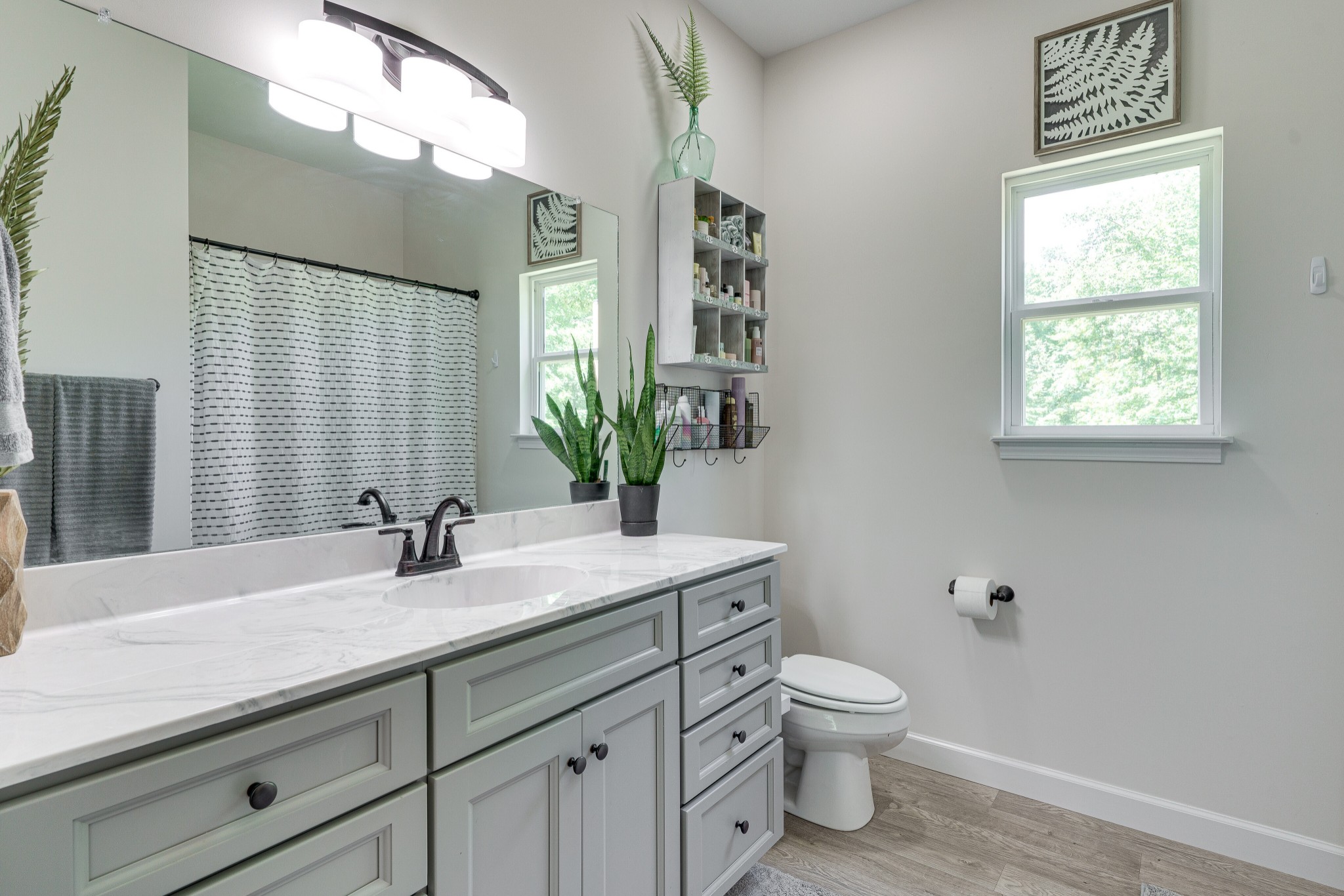 1170 Cowan Road Dickson, TN 37055 - Photo 19 of 30 a bathroom with a granite countertop sink a toilet and a mirror