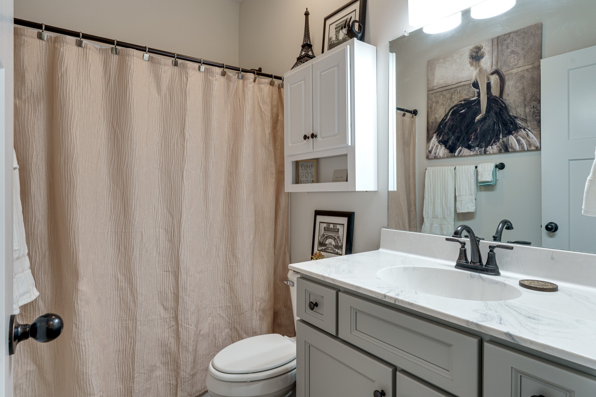 1170 Cowan Road Dickson, TN 37055 - Photo 23 of 30 a bathroom with a sink a toilet and shower curtain