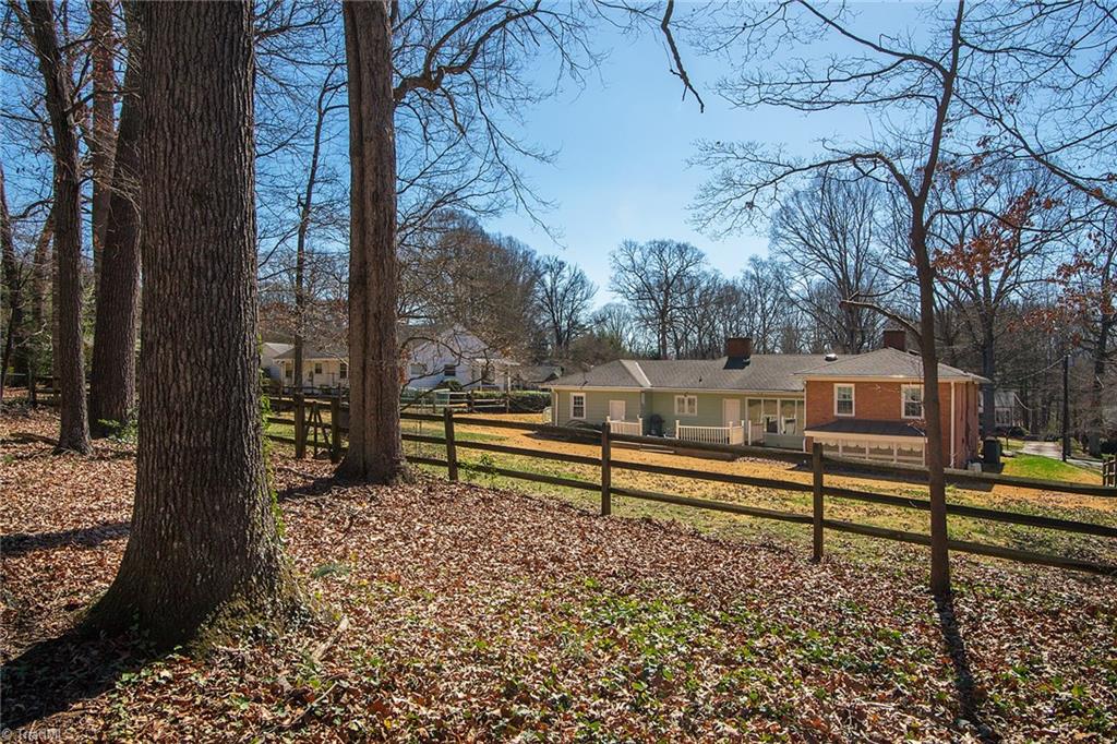 3333 Nottingham Road Winston-Salem, NC 27104 - Photo 24 of 25 A split-rail fence divides the wooded part of the yard from the grass.