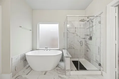 a bathroom with a bathtub and shower
