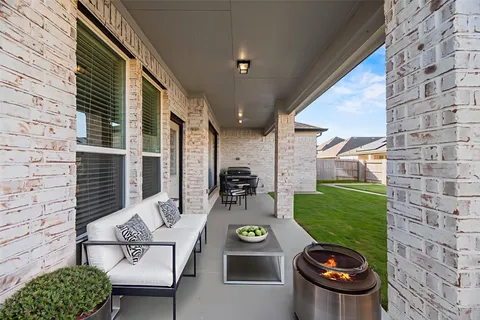 a view of a patio with table and chairs potted plants with sky view