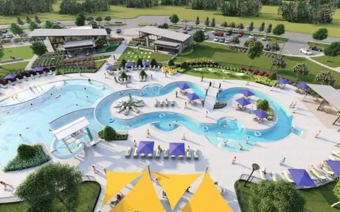 an aerial view of a swimming pool with outdoor seating