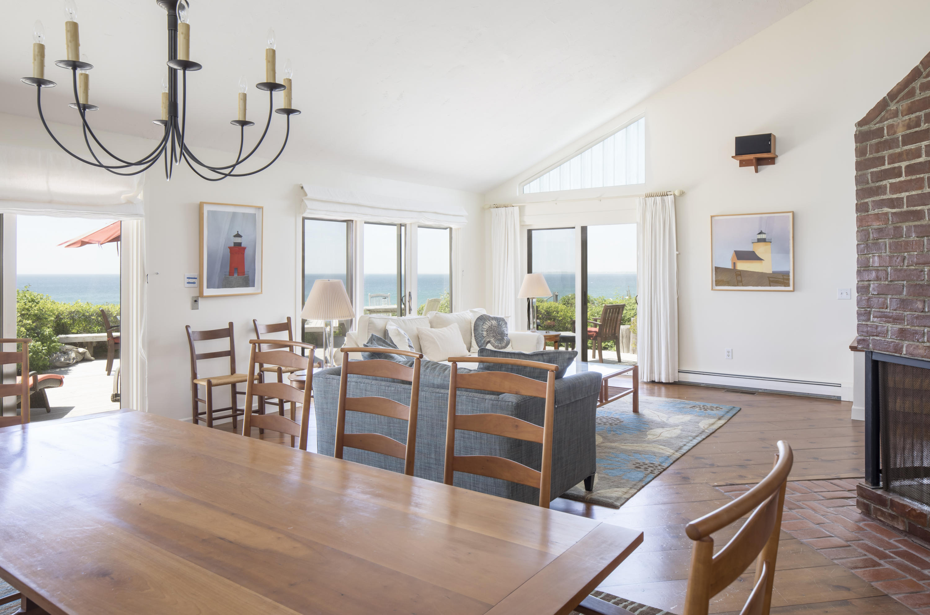 19 Avocet Road Truro, MA 02666 - Photo 8 of 26 a living room with furniture a large window and a chandelier