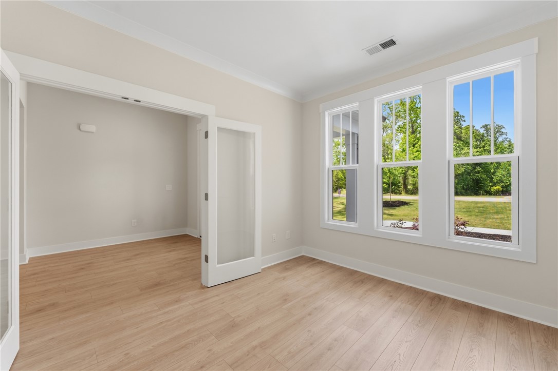 203 Timothy Court Anderson, SC 29621 - Photo 27 of 40 Sun-filled interior space with abundant natural light, featuring elegant French doors and durable hardwood flooring.