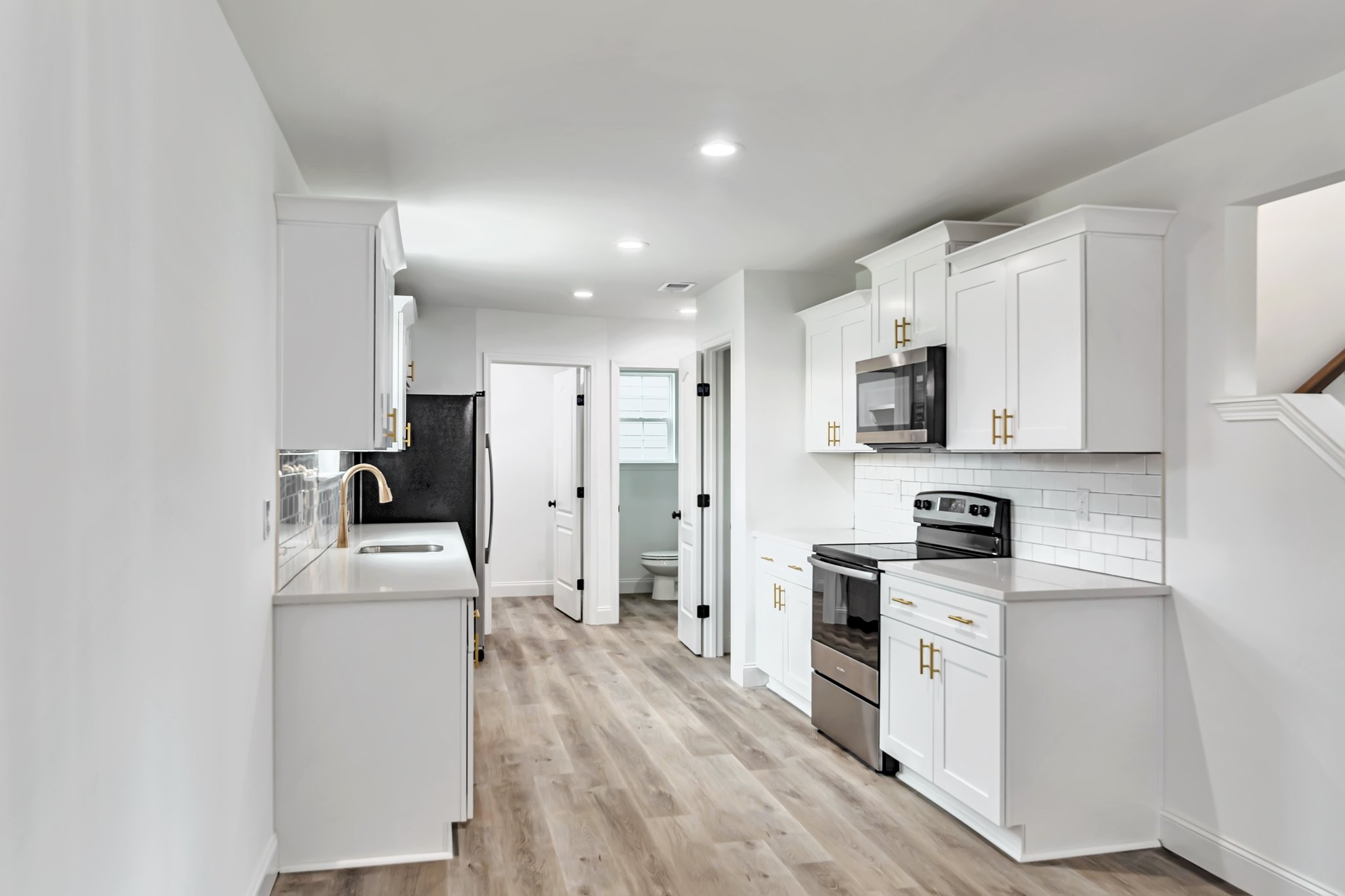 420 Larkin Springs Road Madison, TN 37115 - Photo 7 of 27 a kitchen with white cabinets and stainless steel appliances