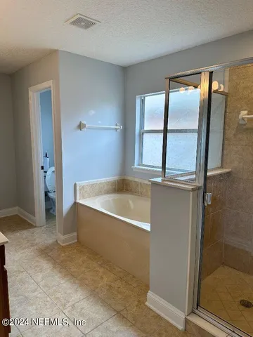 a spacious bathroom with a tub and shower