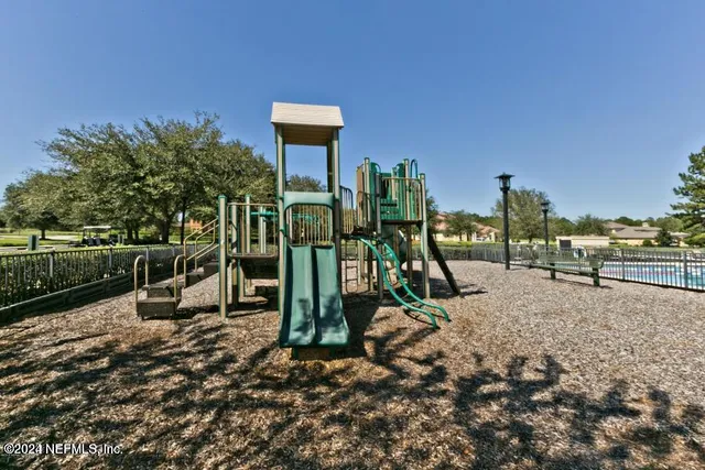 a view of a park with swings and slides