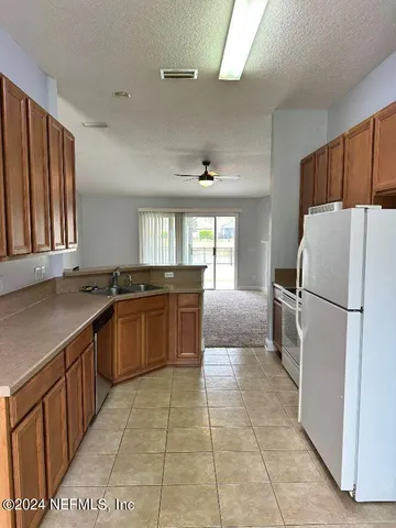 a kitchen with a refrigerator a sink and dishwasher