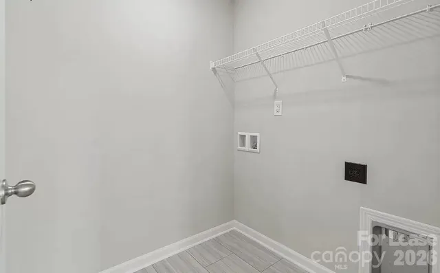 a view of a room with shelf and wooden floor