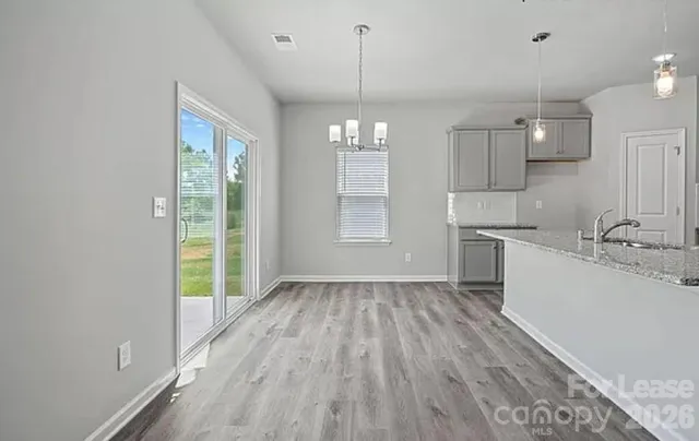 a view of a kitchen and an empty room