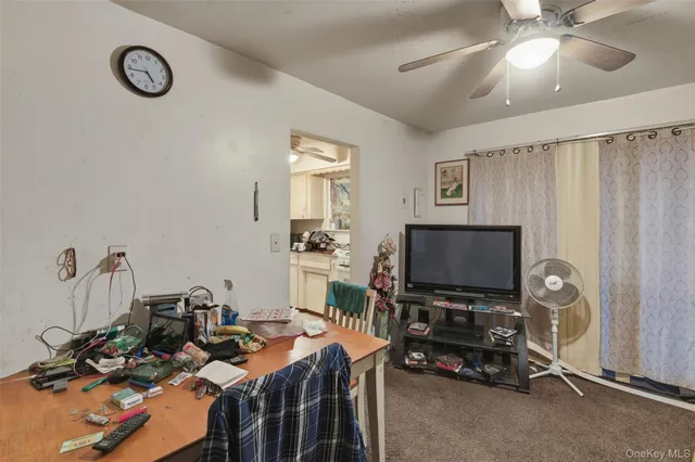 a view of a livingroom with furniture and a flat screen tv