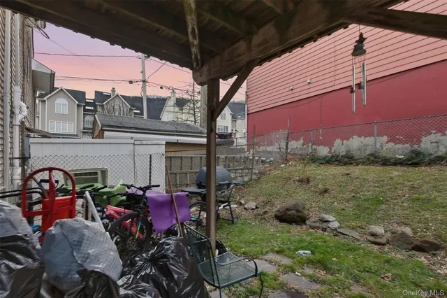 a view of a patio with table and chairs under an umbrella